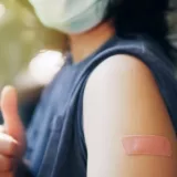 Young female with a vaccine bandage