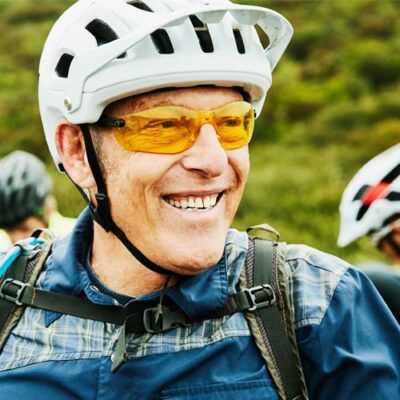 A male subject smiling with bicycle helmet