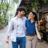 A couple hugging each other walking in the street